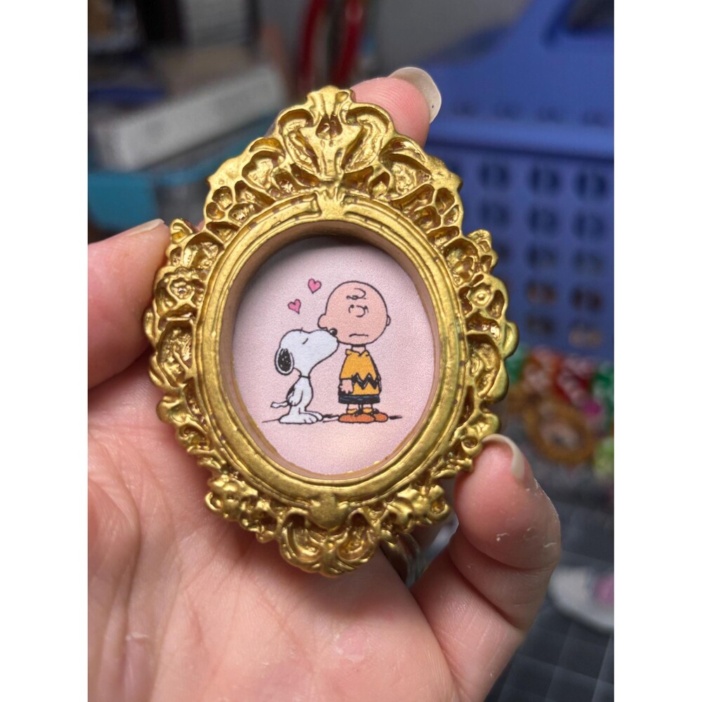 Charlie Brown and Snoopy in a gold framed magnet